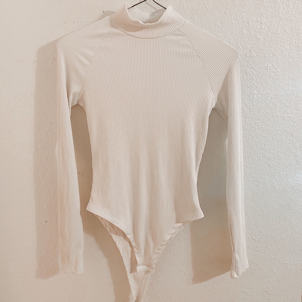 white turtle neck body suit!